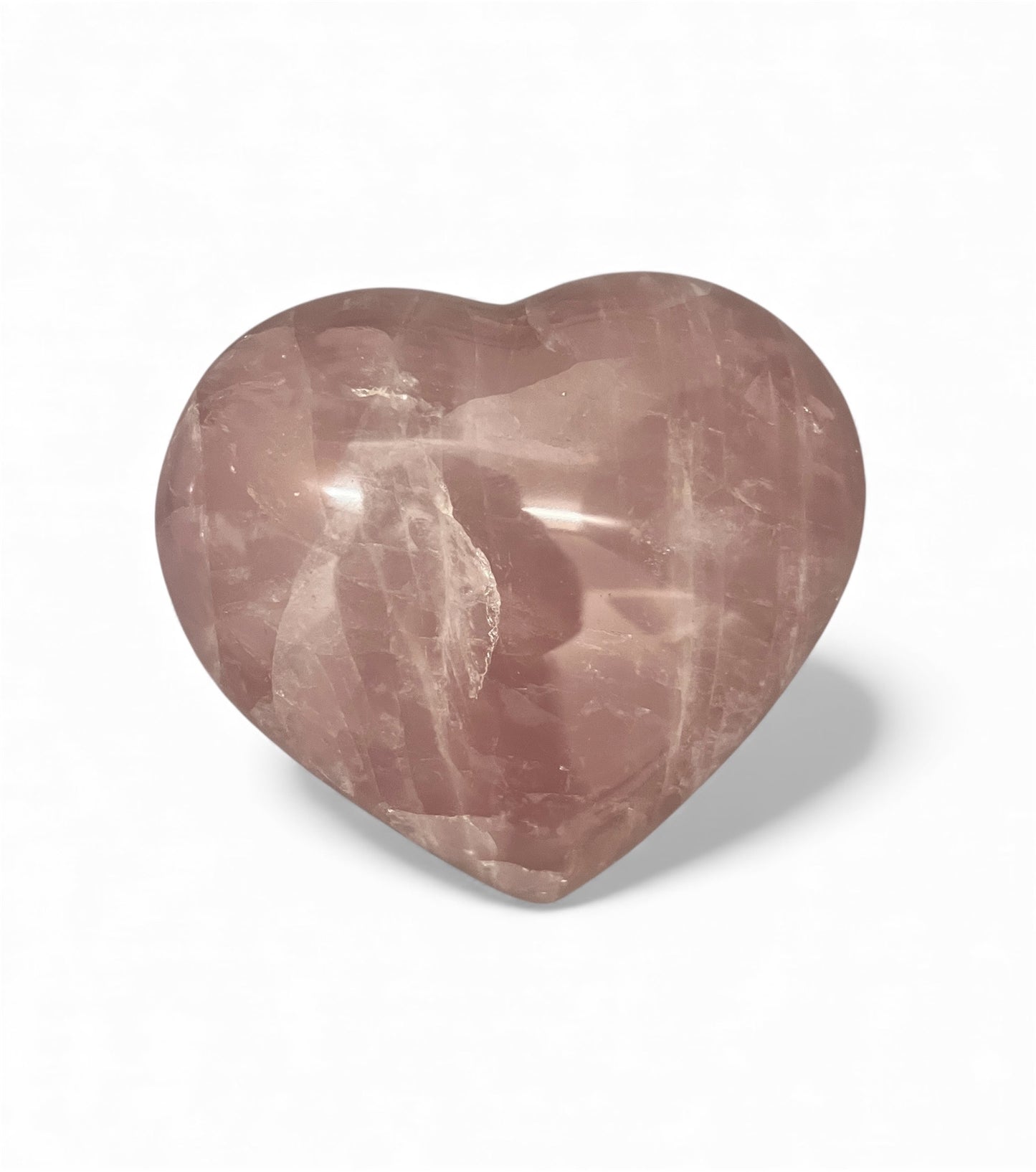 Heart-shaped rose quartz crystal on a white background