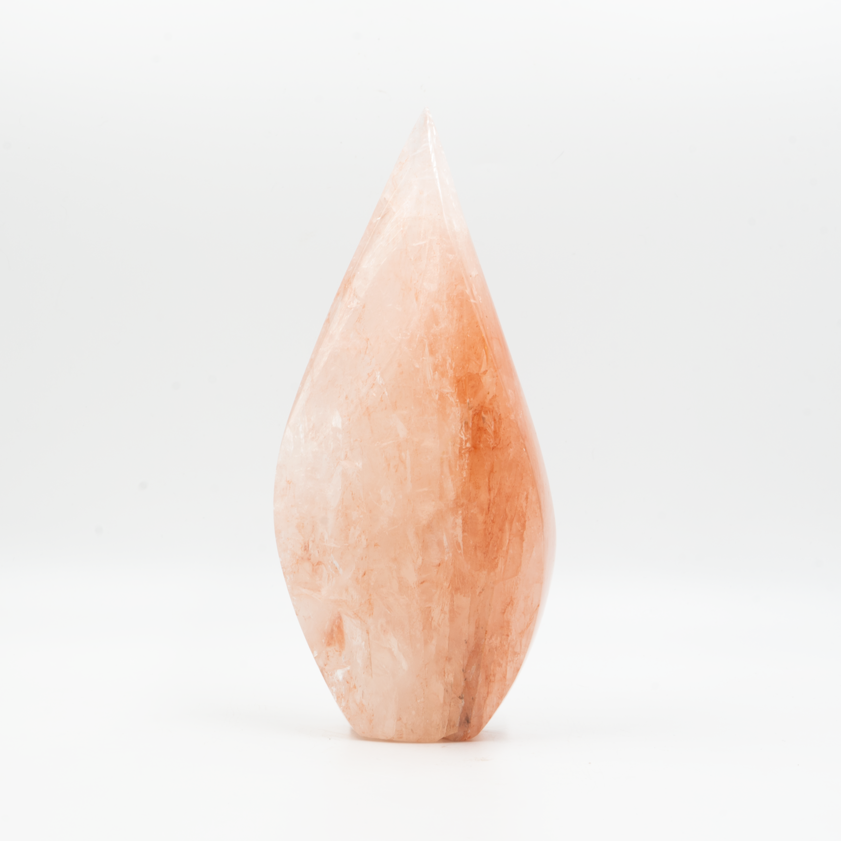 Polished hematoid quartz flame sculpture with soft peach and russet inclusions. Hand-carved into an elegant teardrop form with natural sheen.
