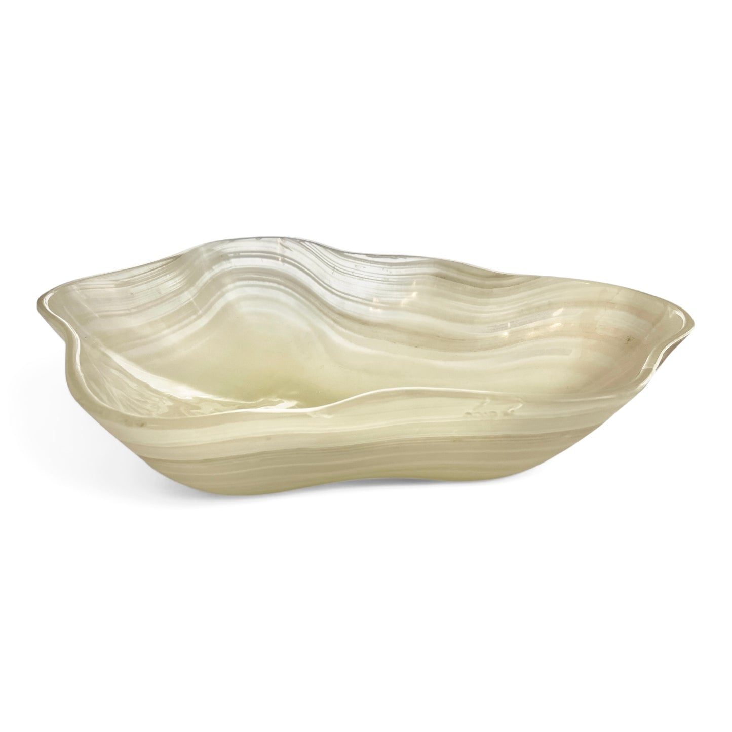 Milky white Onyx bowl in scalloped shape with natural wavy inclusions on a white background