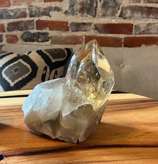 statement natural citrine from brazil on wood surface with bricks in background