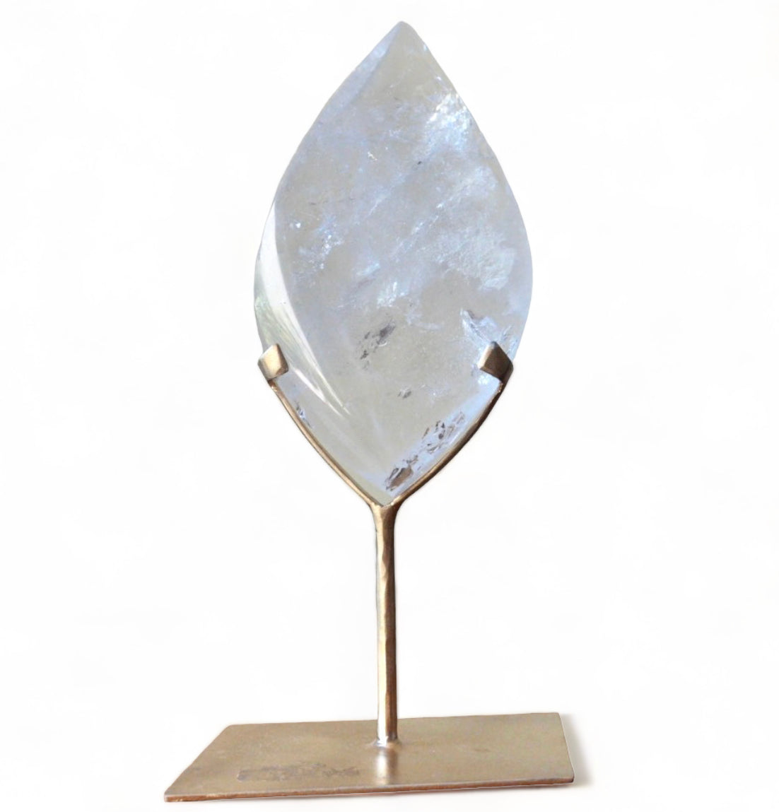 A clear quartz double pointed flame on a bronze stand.