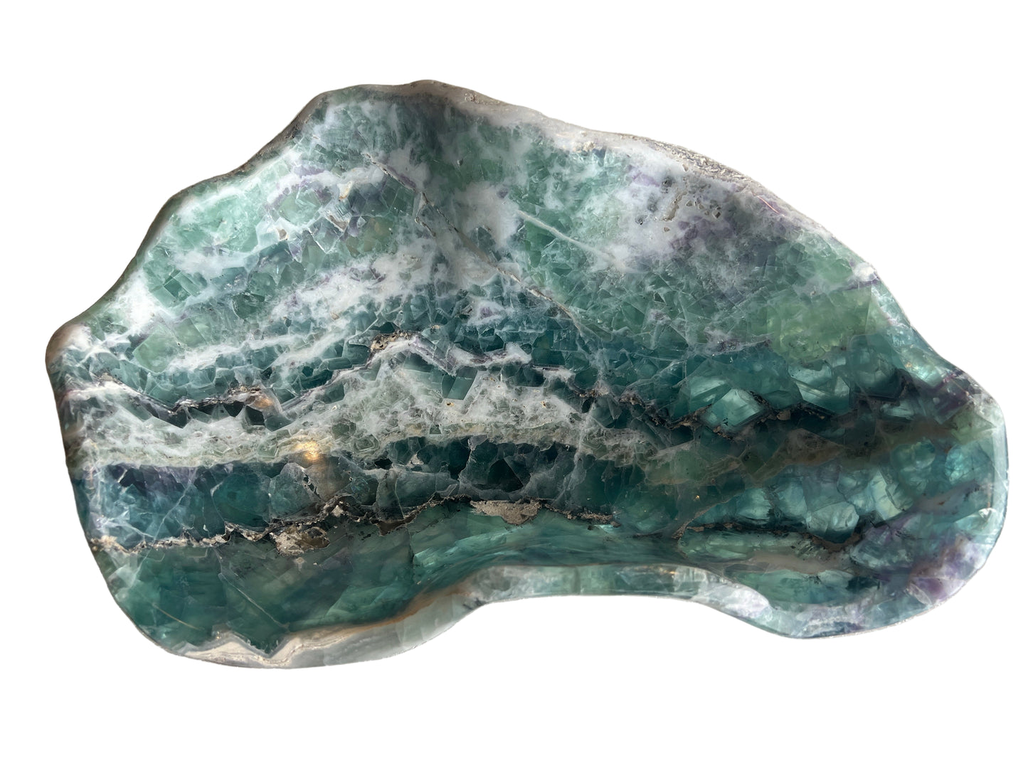 freeform green fluorite on white background photographed from above