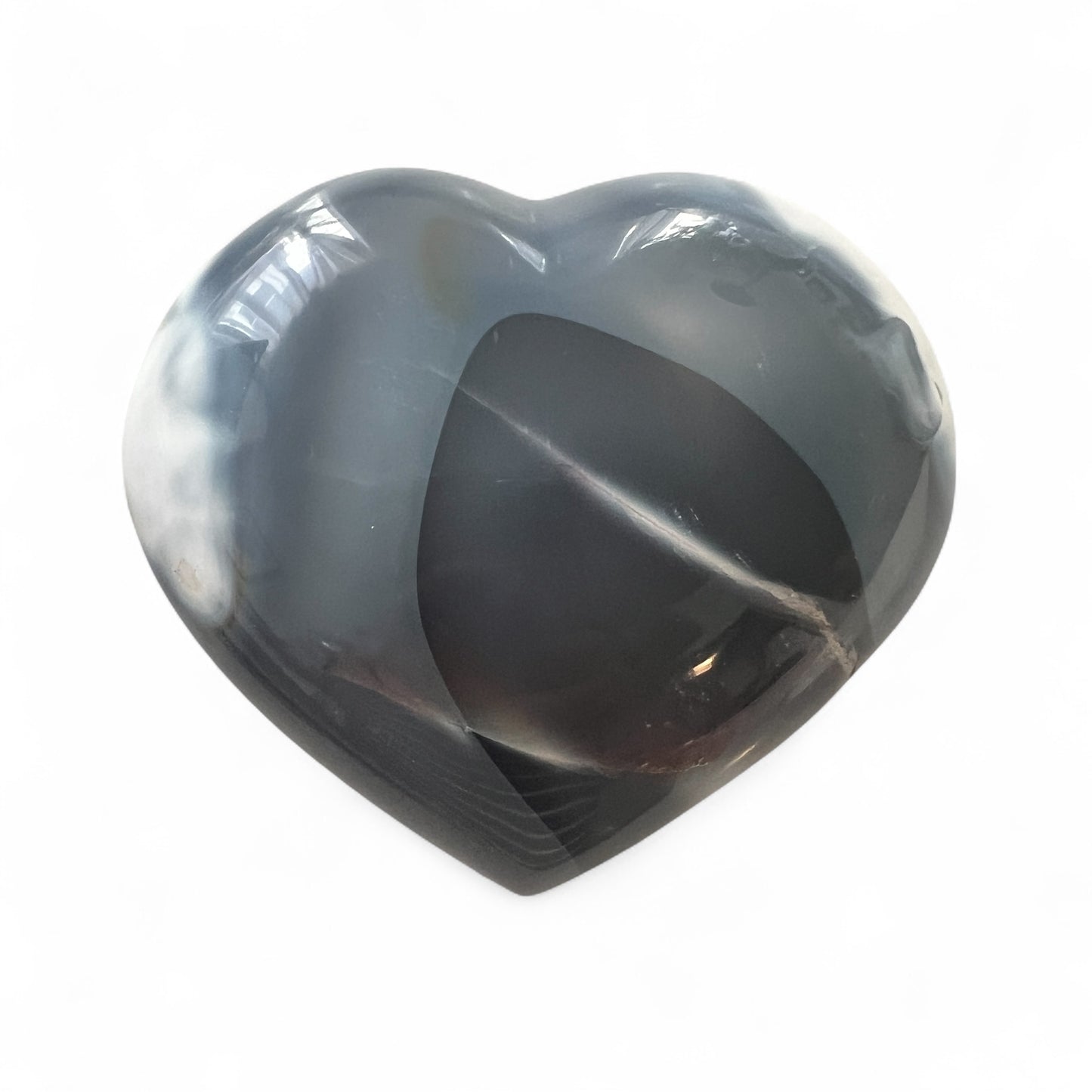 Heart-shaped stone with gray and blue patterns on a white background