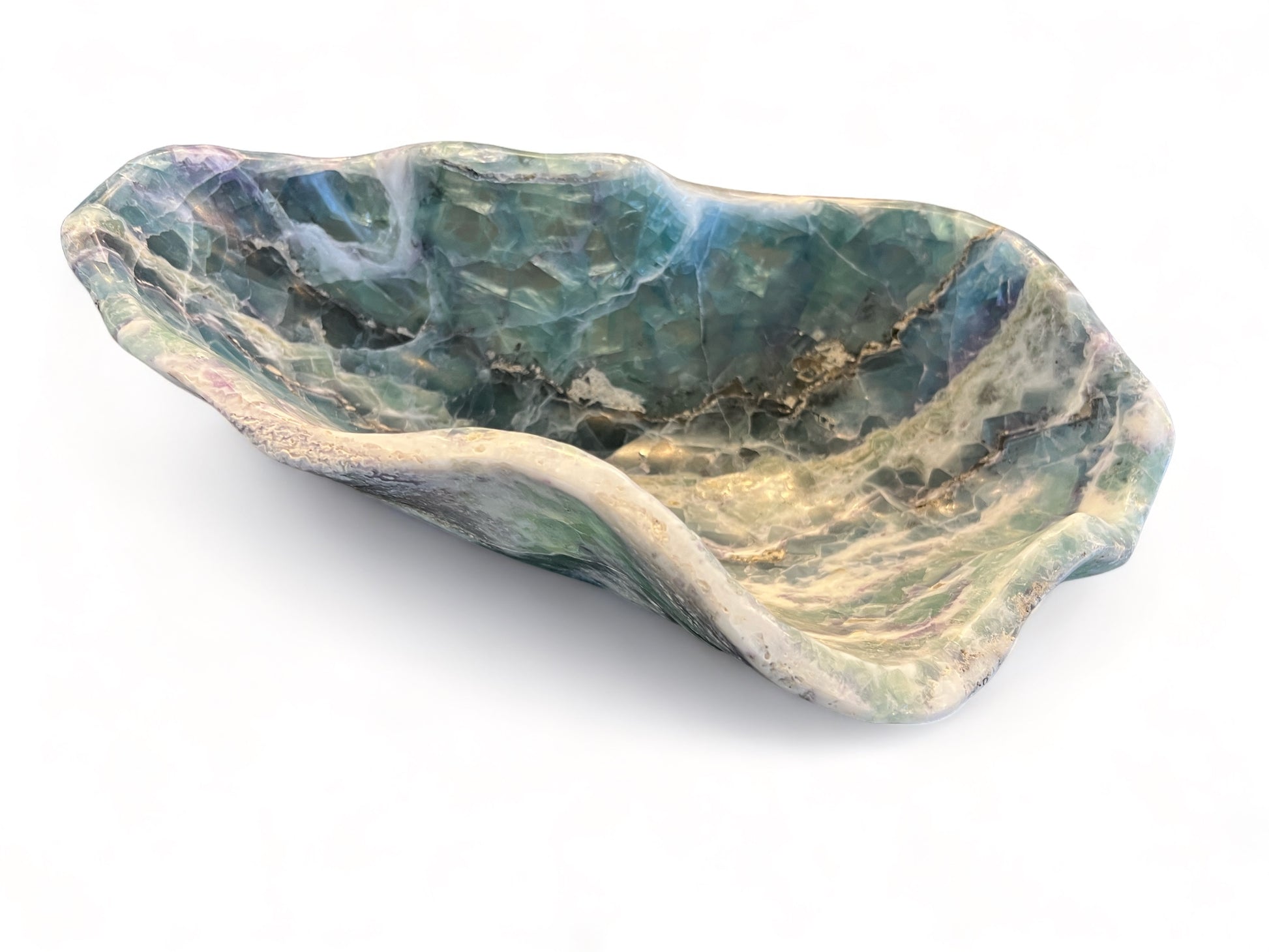 Hand-carved rainbow fluorite crystal bowl with bright blue and green bands, styled as a sculptural centerpiece