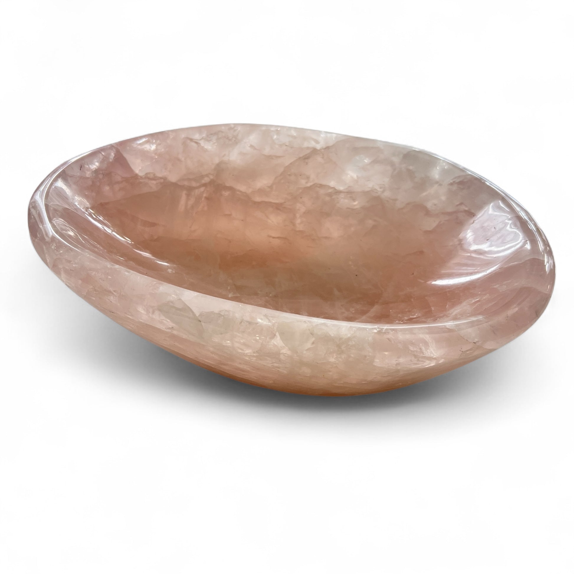 Rose quartz crystal bowl on a white background