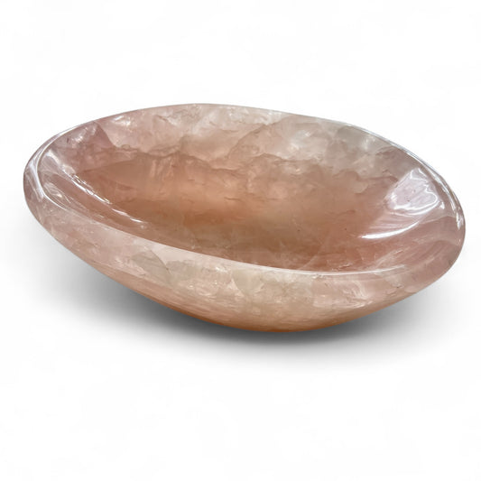 Rose quartz crystal bowl on a white background