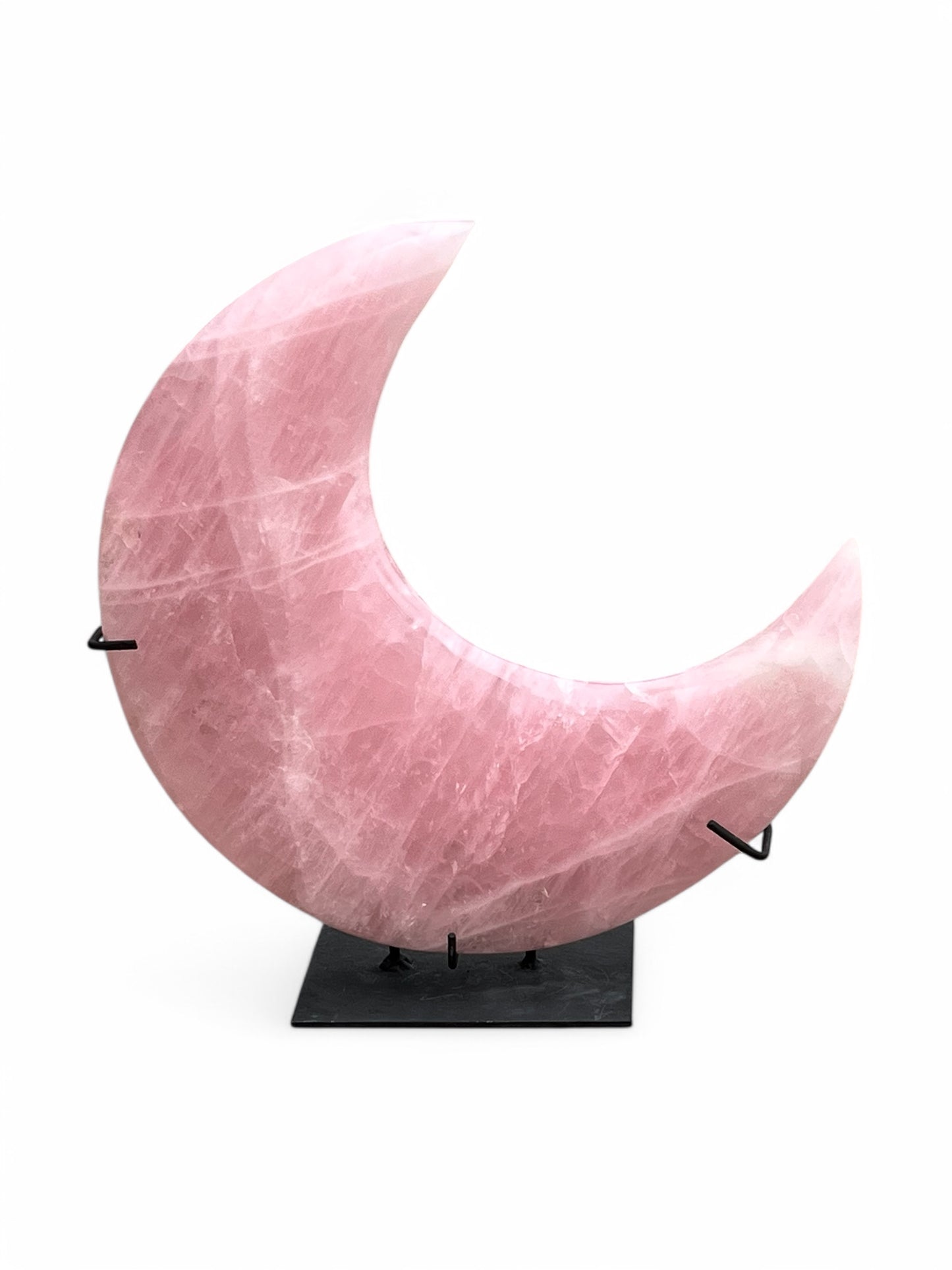 pink quartz moon on black stand white background