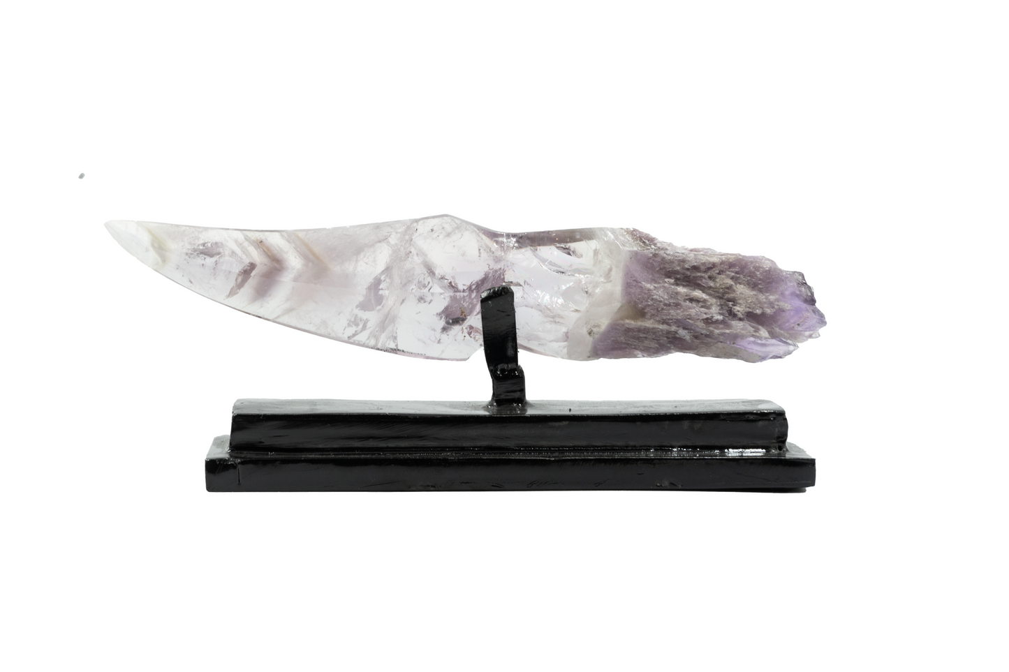 A chevron amethyst crystal dagger with a raw amethyst handle on a black stand.