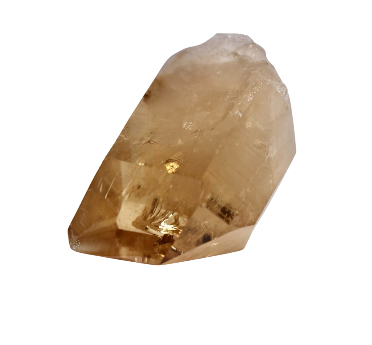 A polished natural Brazilian citrine crystal with a yellow to brownish color, displayed against a white background.