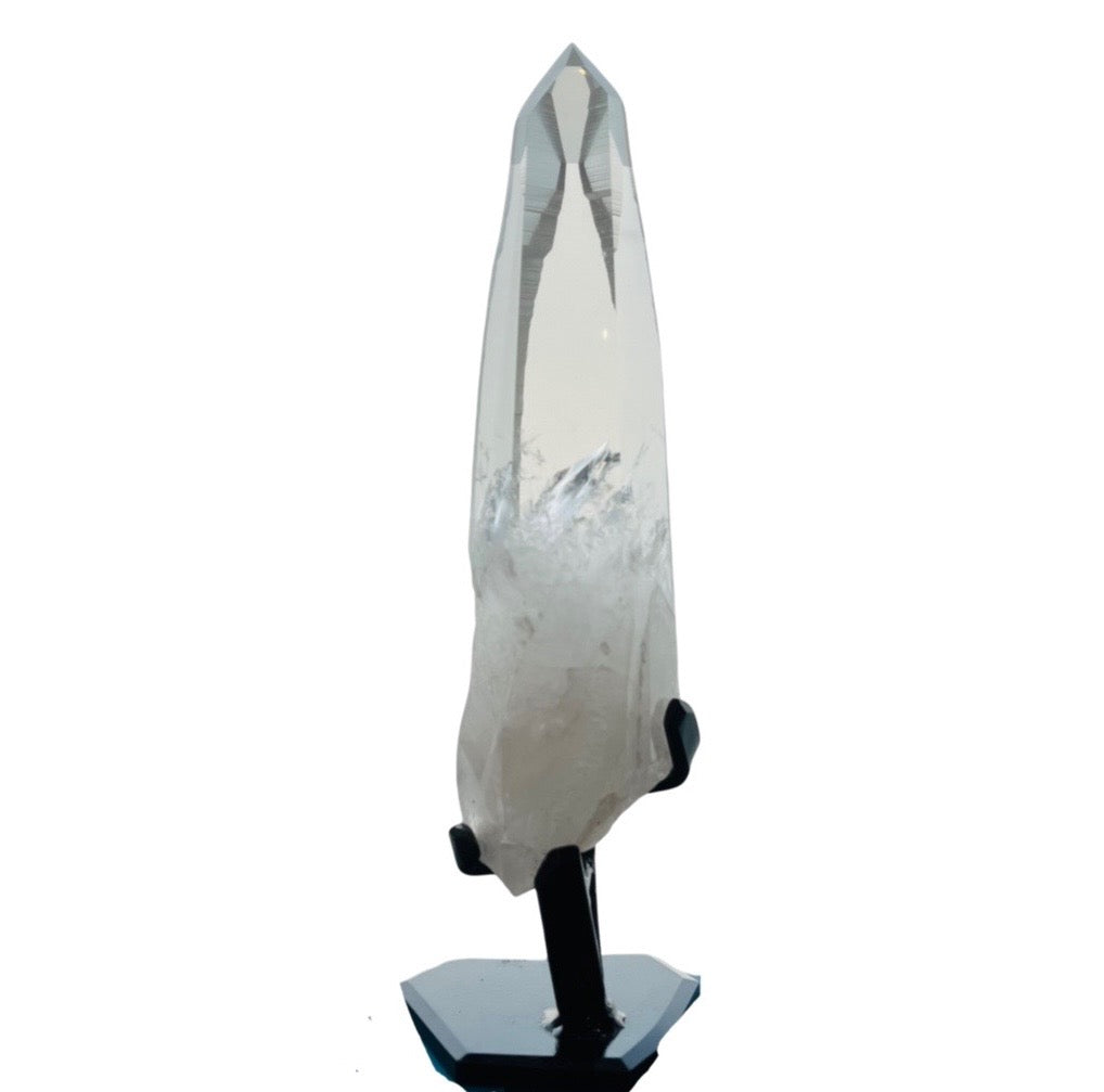 A Lemurian Quartz crystal mounted on a stand, displaying a clear pointy end and milky body with black accents.