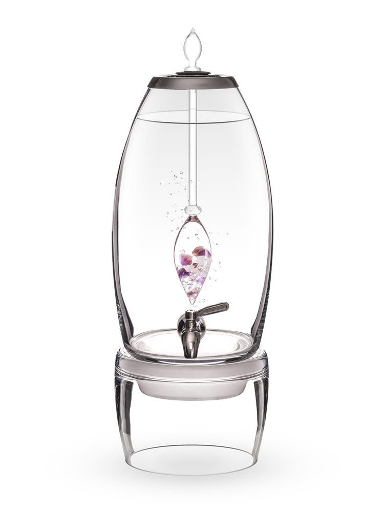 Grande water dispenser shown with crystal infusion vial in modern kitchen setting
