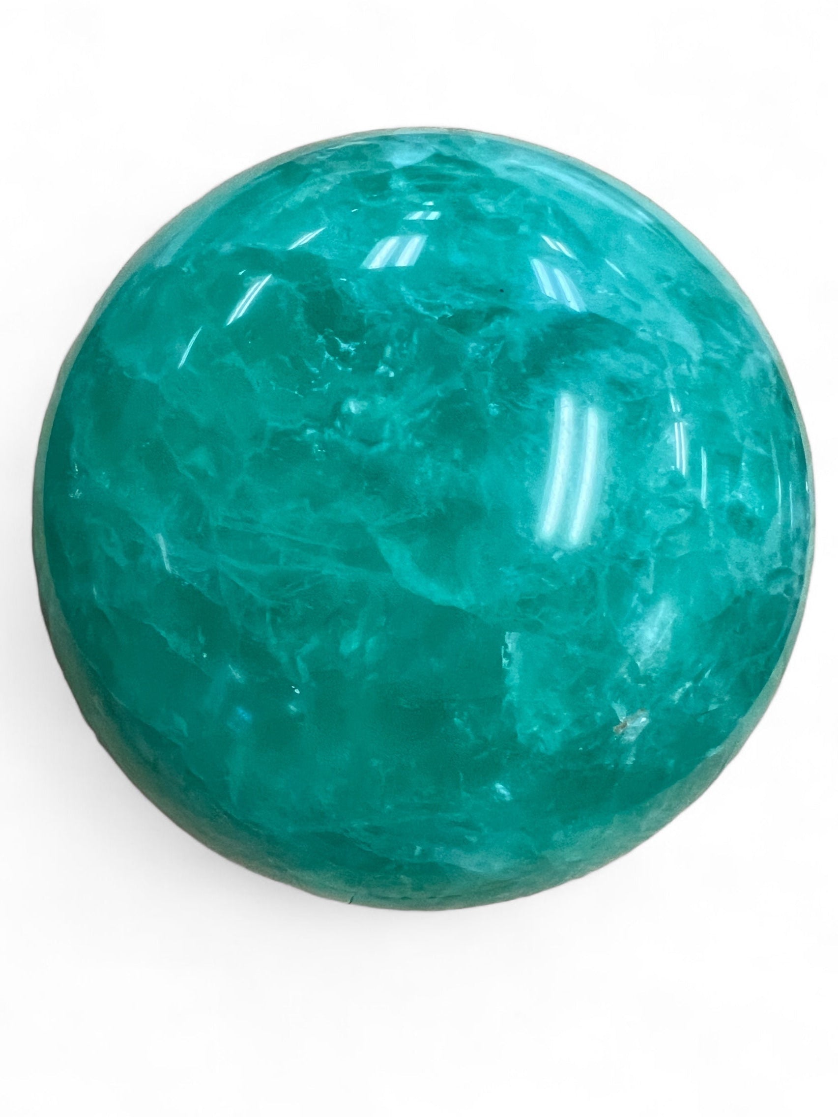 Large green fluorite sphere on white background