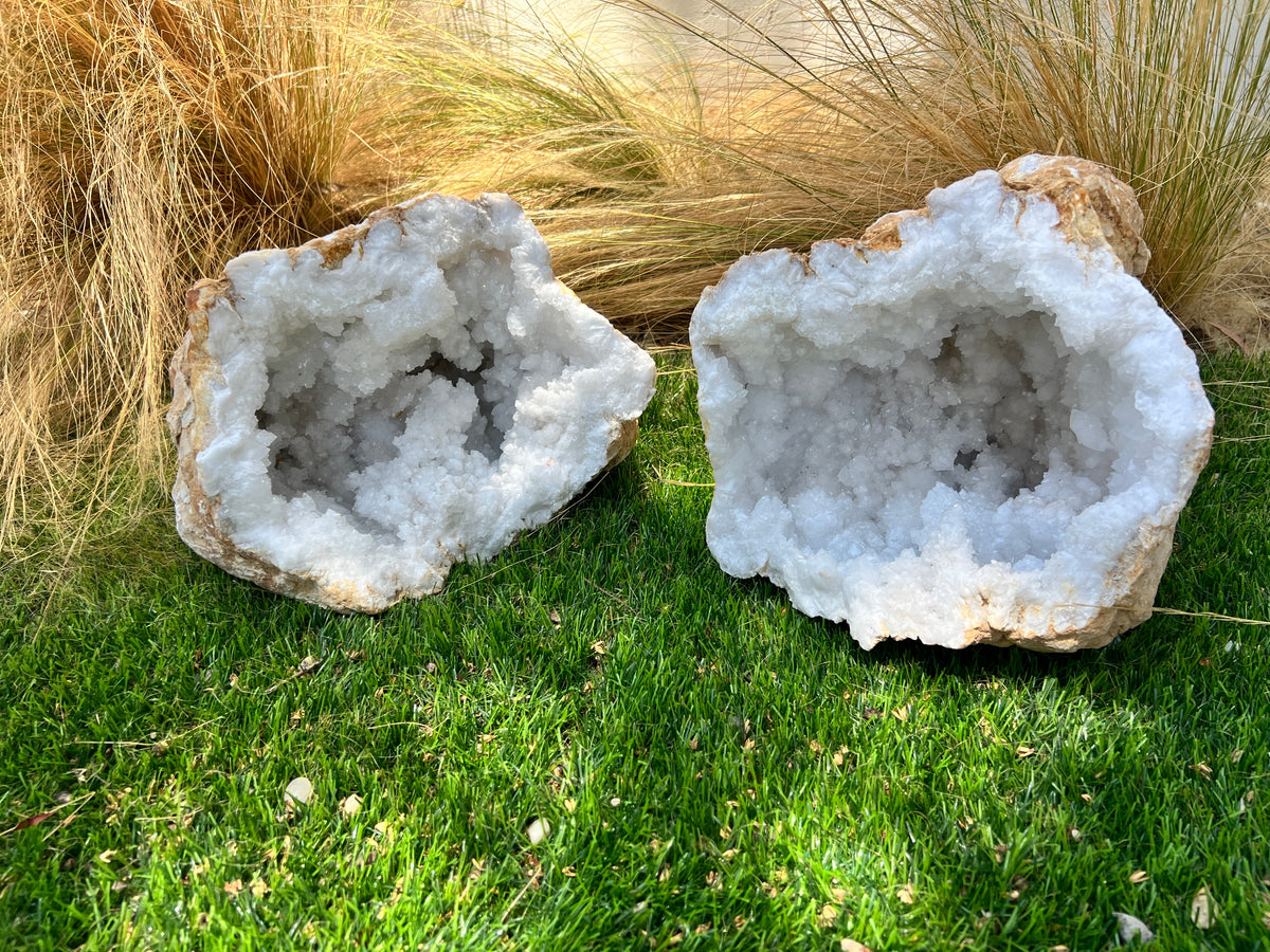 Crystal geode on a wooden table with a vase and basket in the background