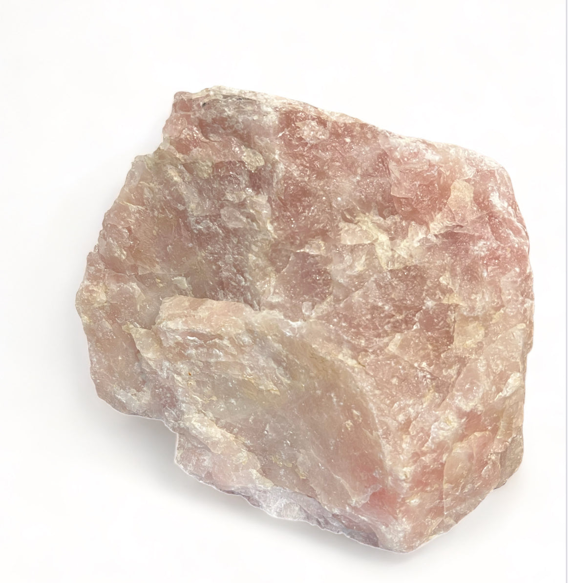 A rough crystal of Rose Quartz with a pinkish hue, displaying natural mineral textures and formations.