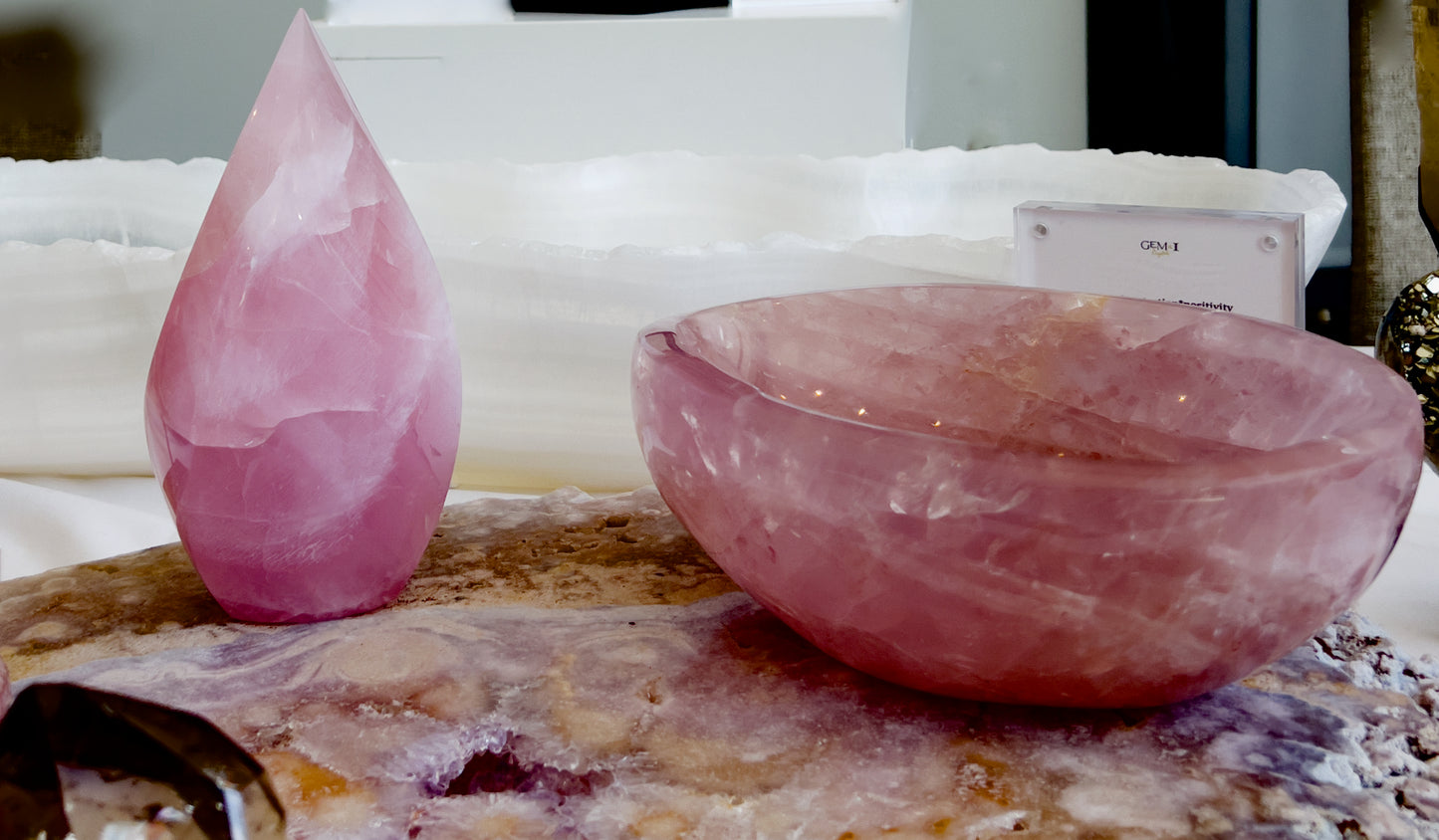 rose quartz flame and bowl on crystal platter with blurred background