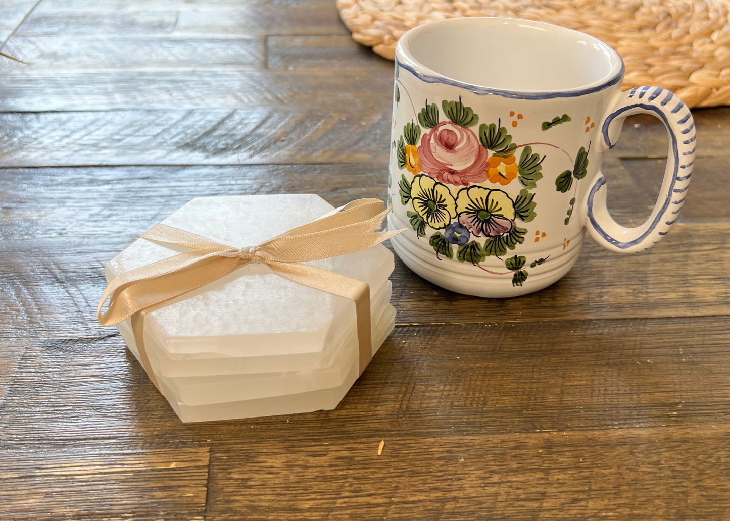 set of 4 white hexagonal shaped coasters with flowery mug on wood table