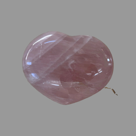 Pink crystal on a beige stone surface