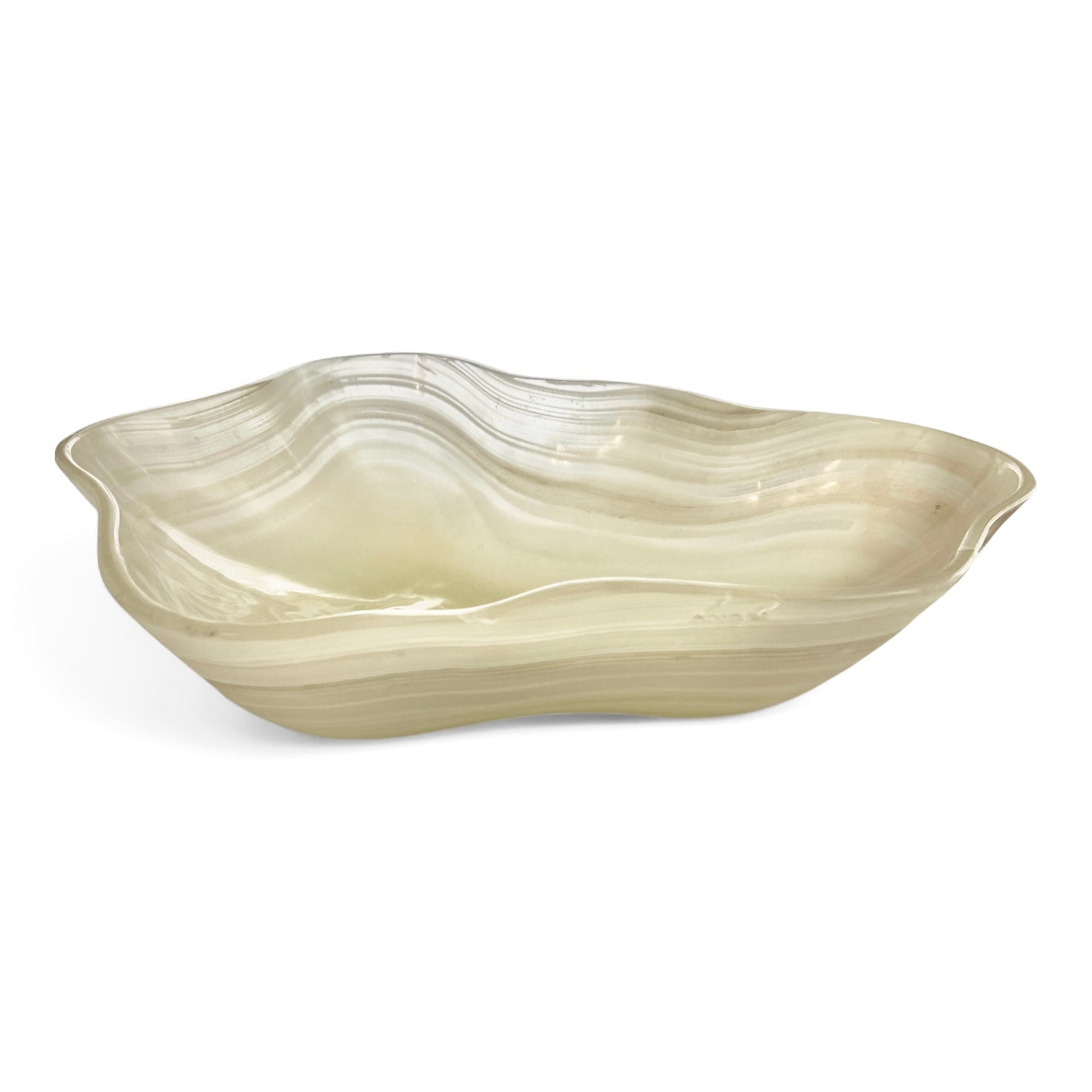 Milky white Onyx bowl in scalloped shape with natural wavy inclusions on a white background