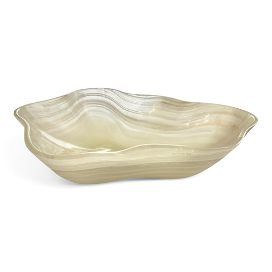 Milky white Onyx bowl in scalloped shape with natural wavy inclusions on a white background