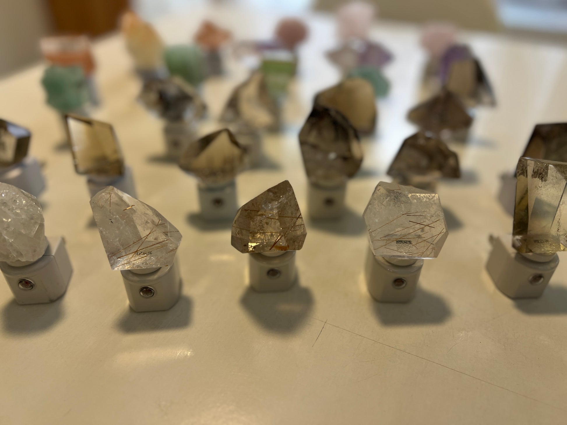 Collection of crystal night lights on a reflective surface