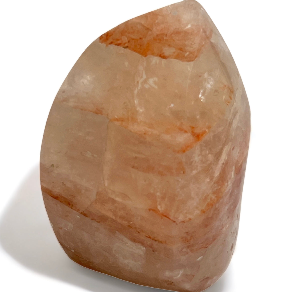 A polished Fire Quartz freeform with visible red/orange veins, showcasing its translucent properties.
