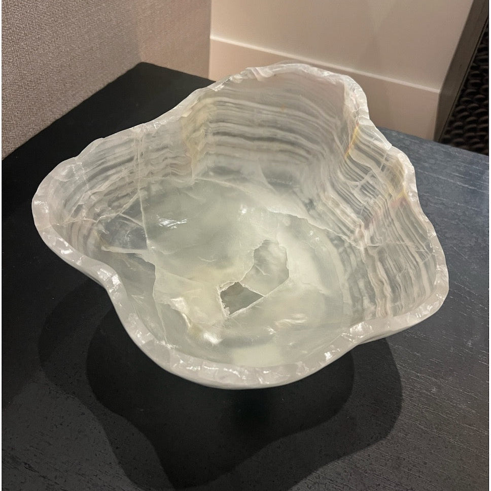 Onyx bowl with textured surface on a dark table