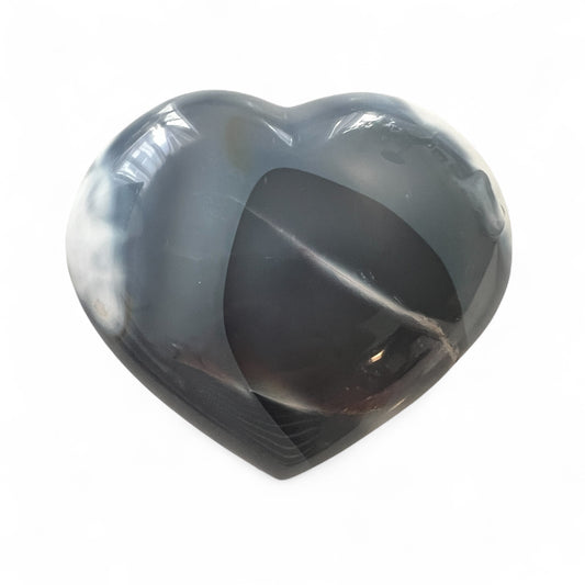 Heart-shaped stone with gray and blue patterns on a white background