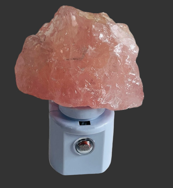 Pink crystal night light on a white background