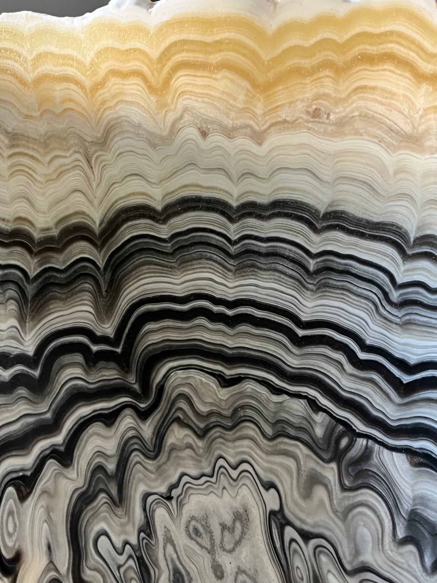 Close-up detail of zebra calcite bowl highlighting organic banding and polished interior