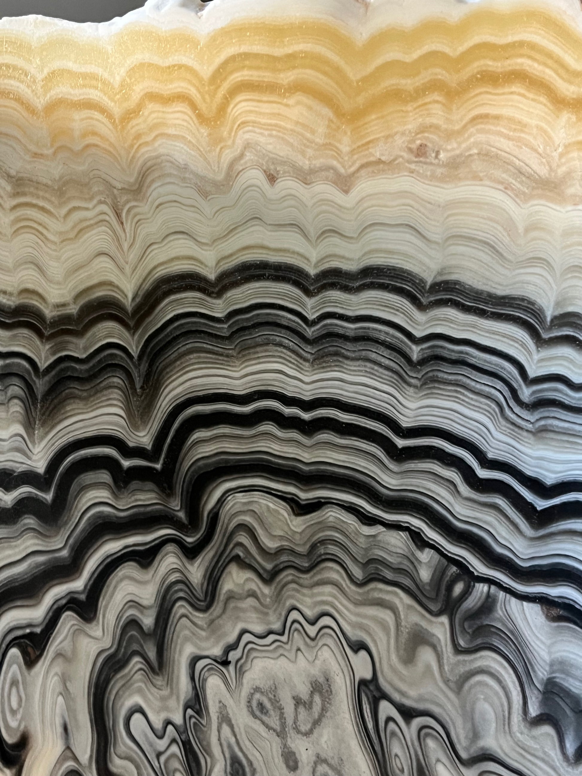 Close-up detail of zebra calcite bowl highlighting organic banding and polished interior