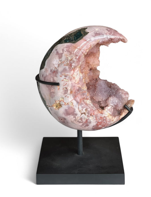 A polished pink amethyst moon-shaped stone on a black iron stand, showcasing natural inclusions and a semi-translucent appearance.