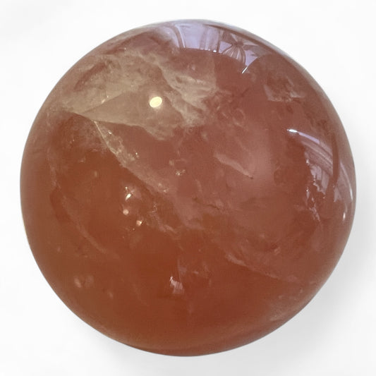 Pink crystal sphere on a white background