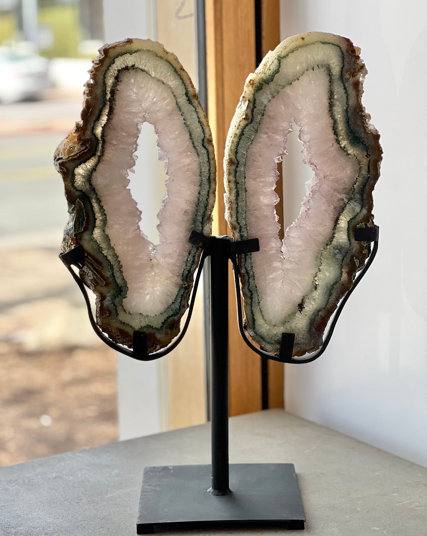 druzy quartz agate butterfly wings on stand in a window