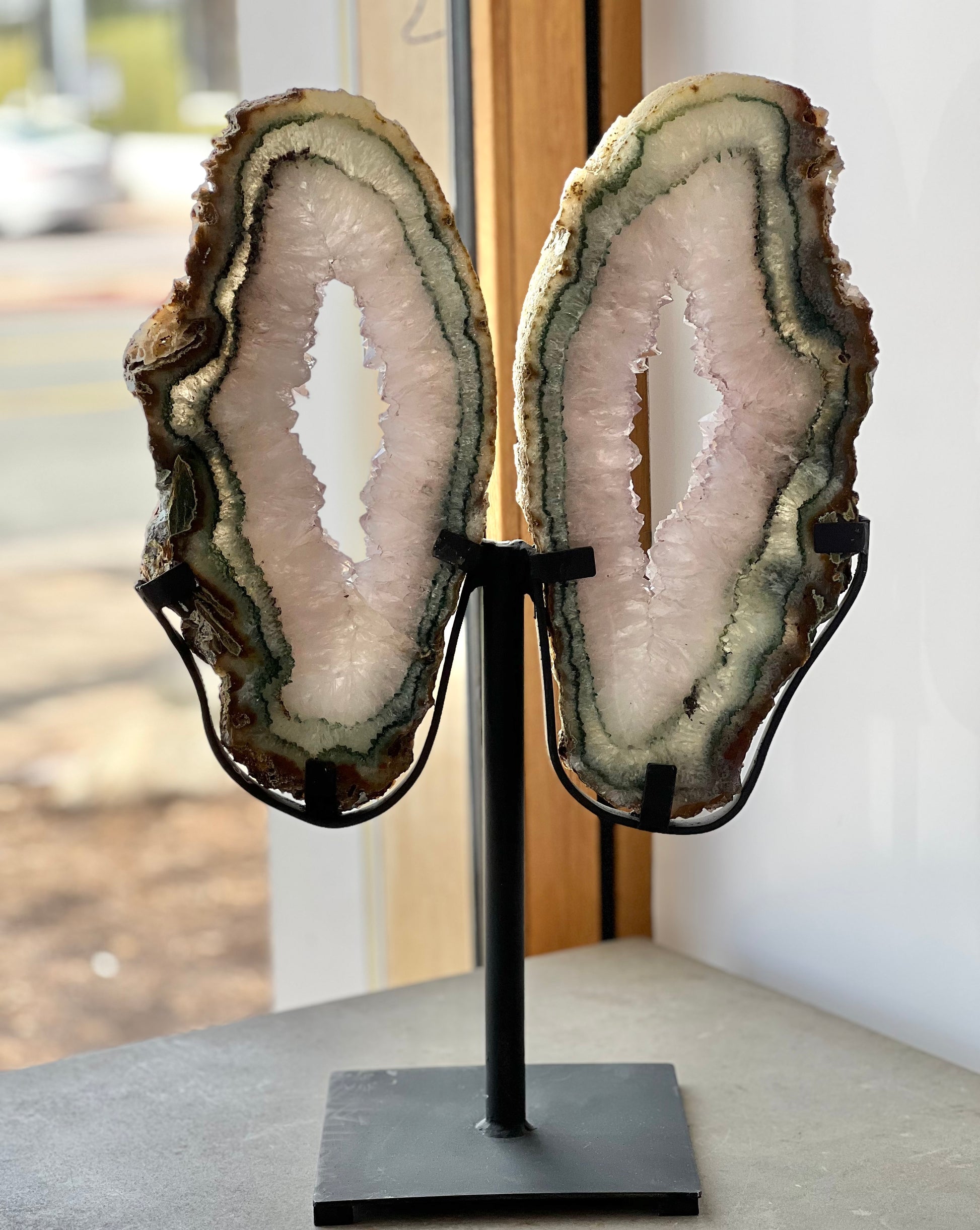 druzy quartz agate butterfly wings on stand in a window