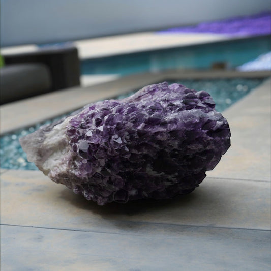 Raw natural amethyst cluster poolside