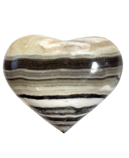Heart-shaped stone with striped pattern on a white background