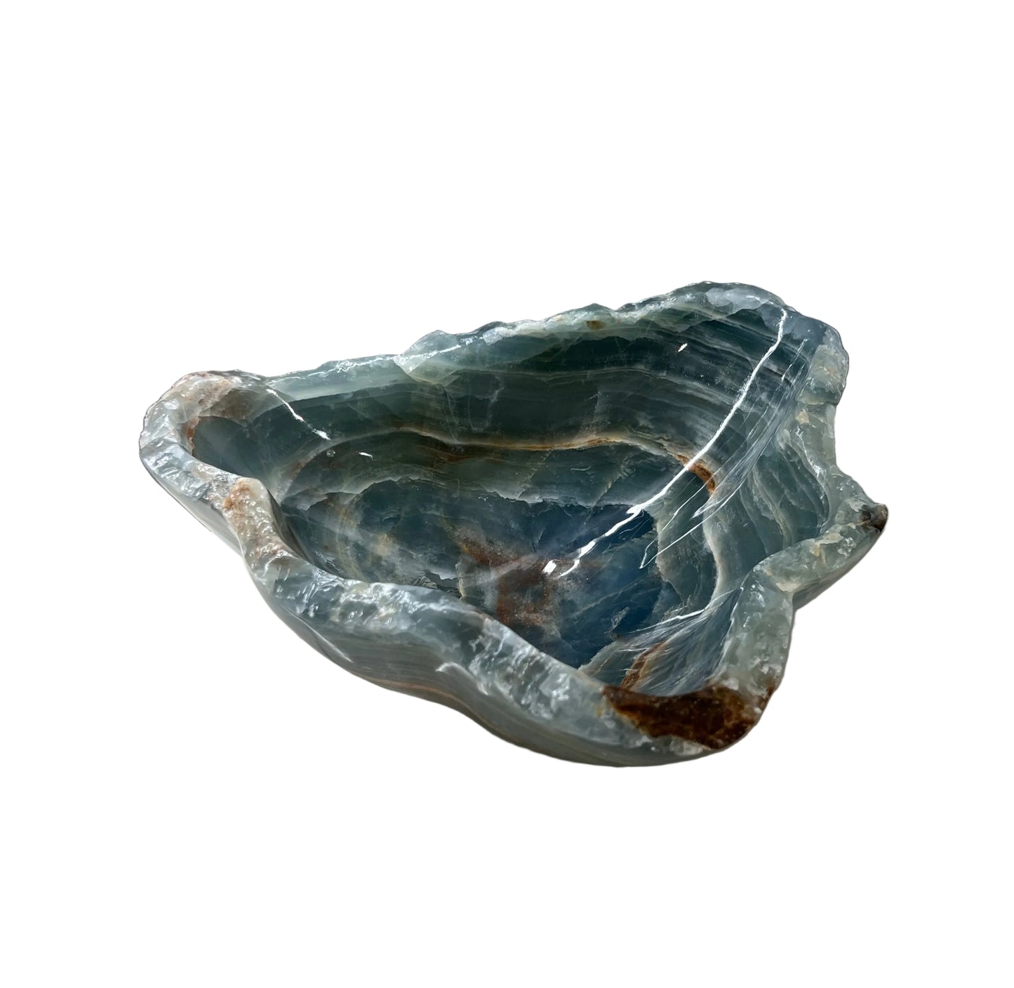 Blue stone bowl on a bathroom counter with tiled wall in the background