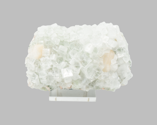 Apophyllite crystal rock on a gray background