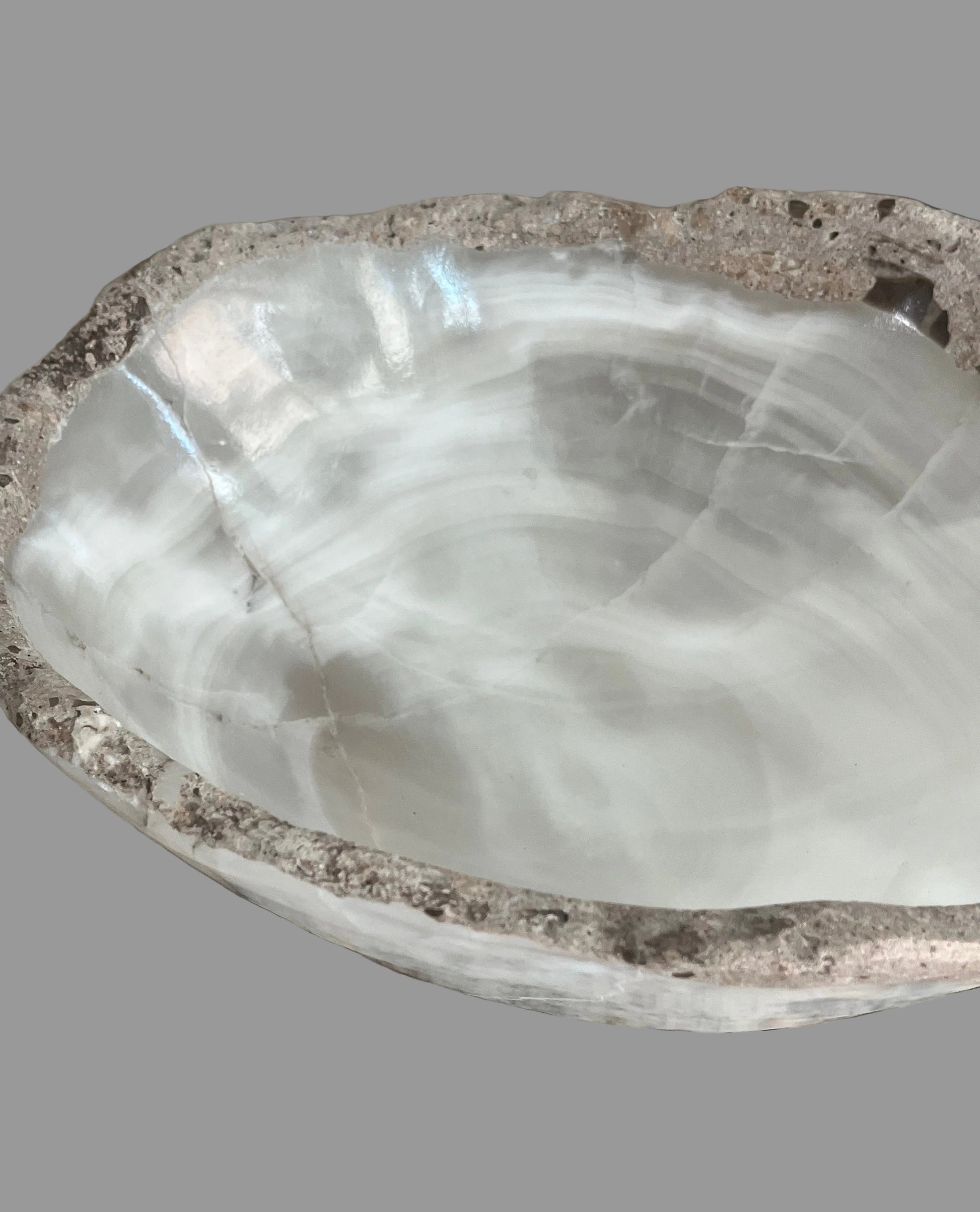 Close-up of white onyx bowl interior showing layered translucent stone