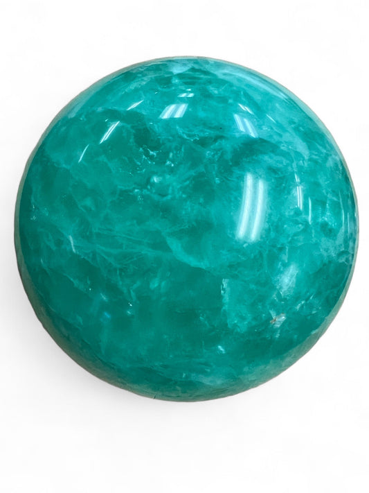 Large green fluorite sphere on white background