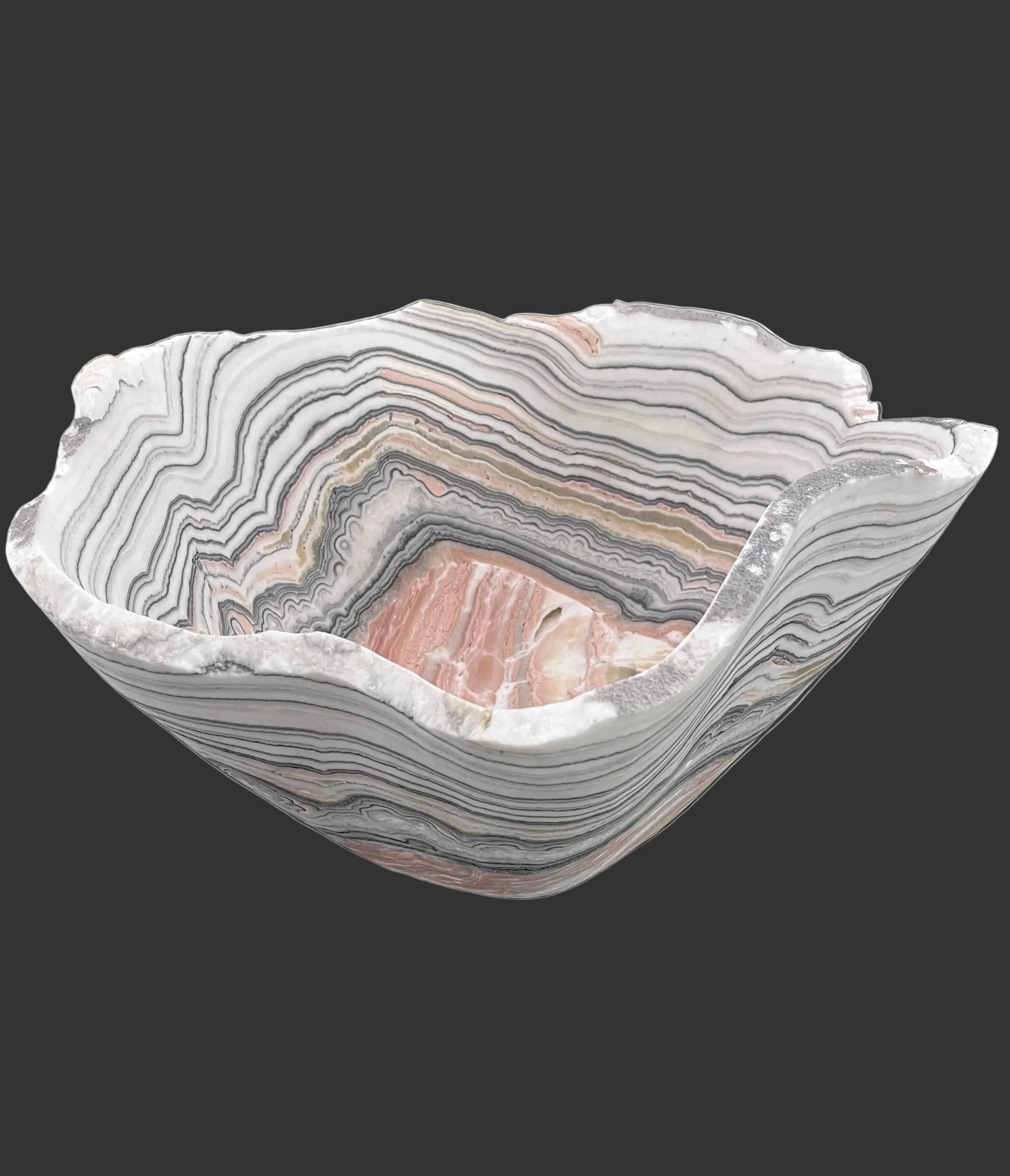 Decorative bowl with zebra calcite pattern on a black surface