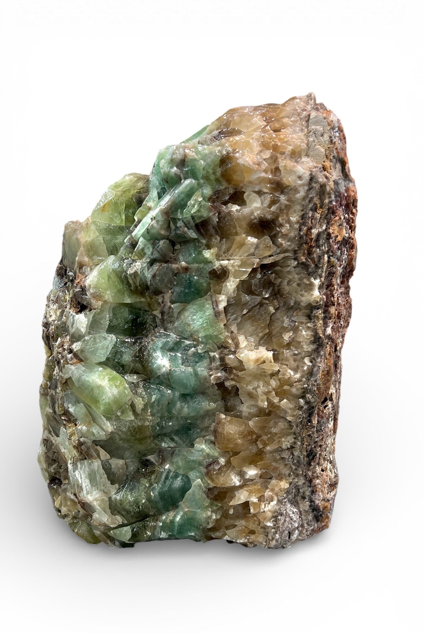 Large natural emerald green calcite stone sculpture with raw crystal texture on white background