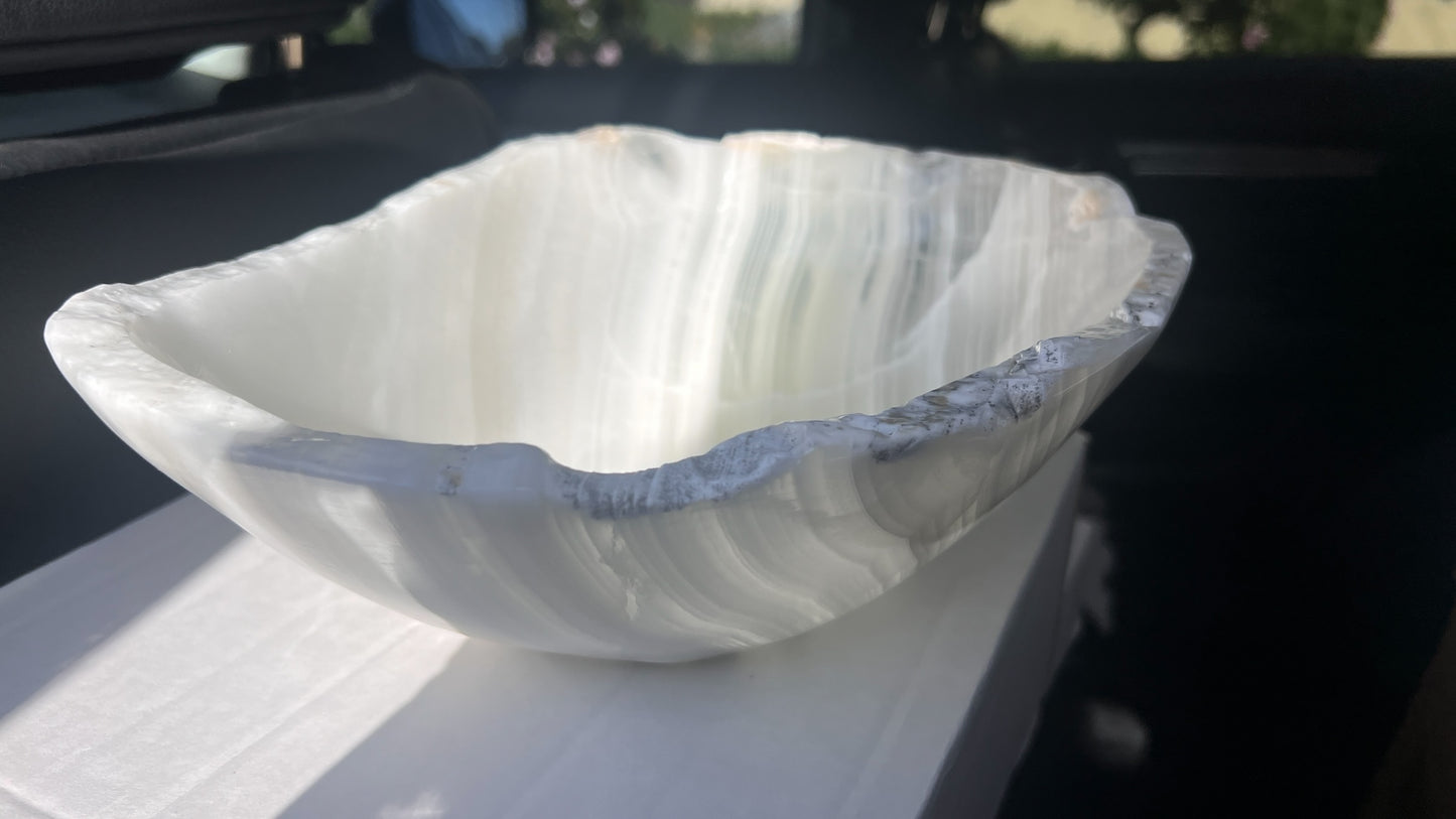 Hand-carved green and white onyx bowl with natural banding and softly organic rim