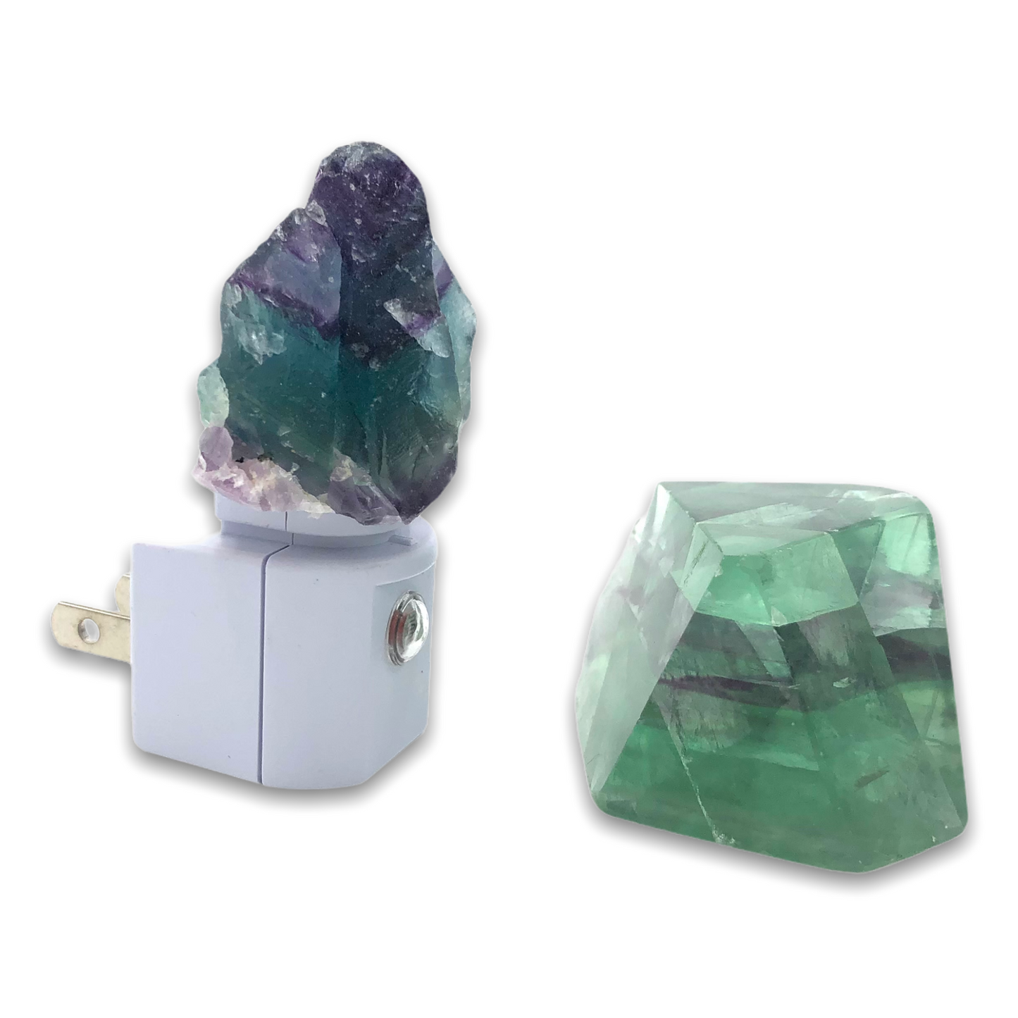 Rainbow fluorite crystal attached to a white led night light base and a green fluorite alone in front of it