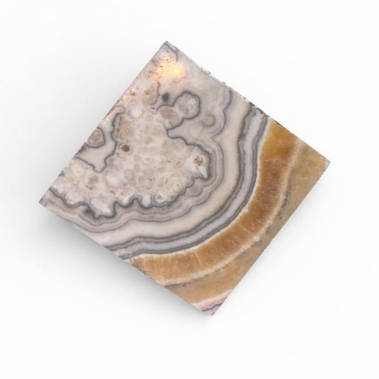 phantom zebra calcite cube with layered gray, ivory, and honey banding that measures 4" cubed