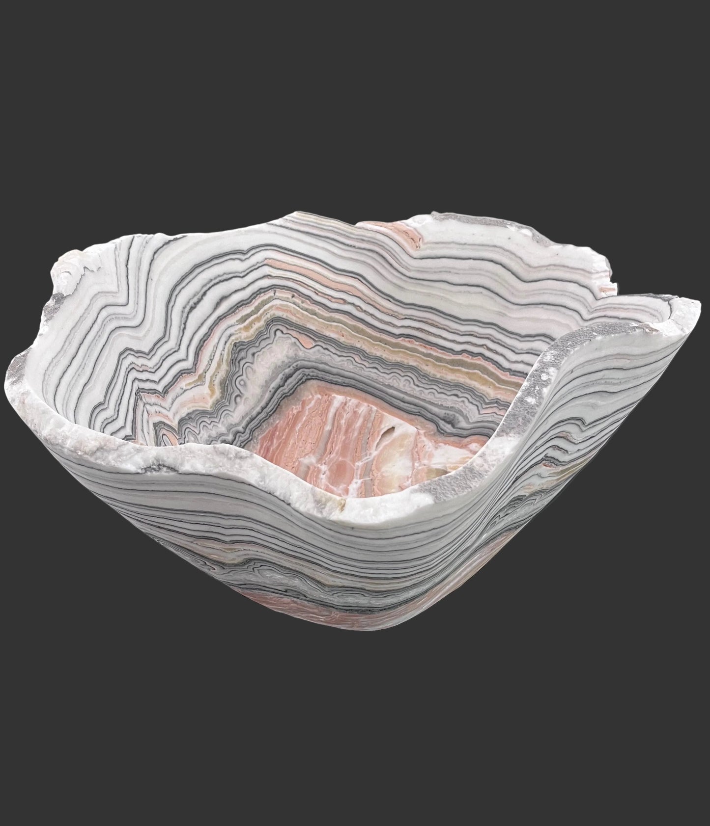 Decorative bowl with zebra calcite pattern on a black surface