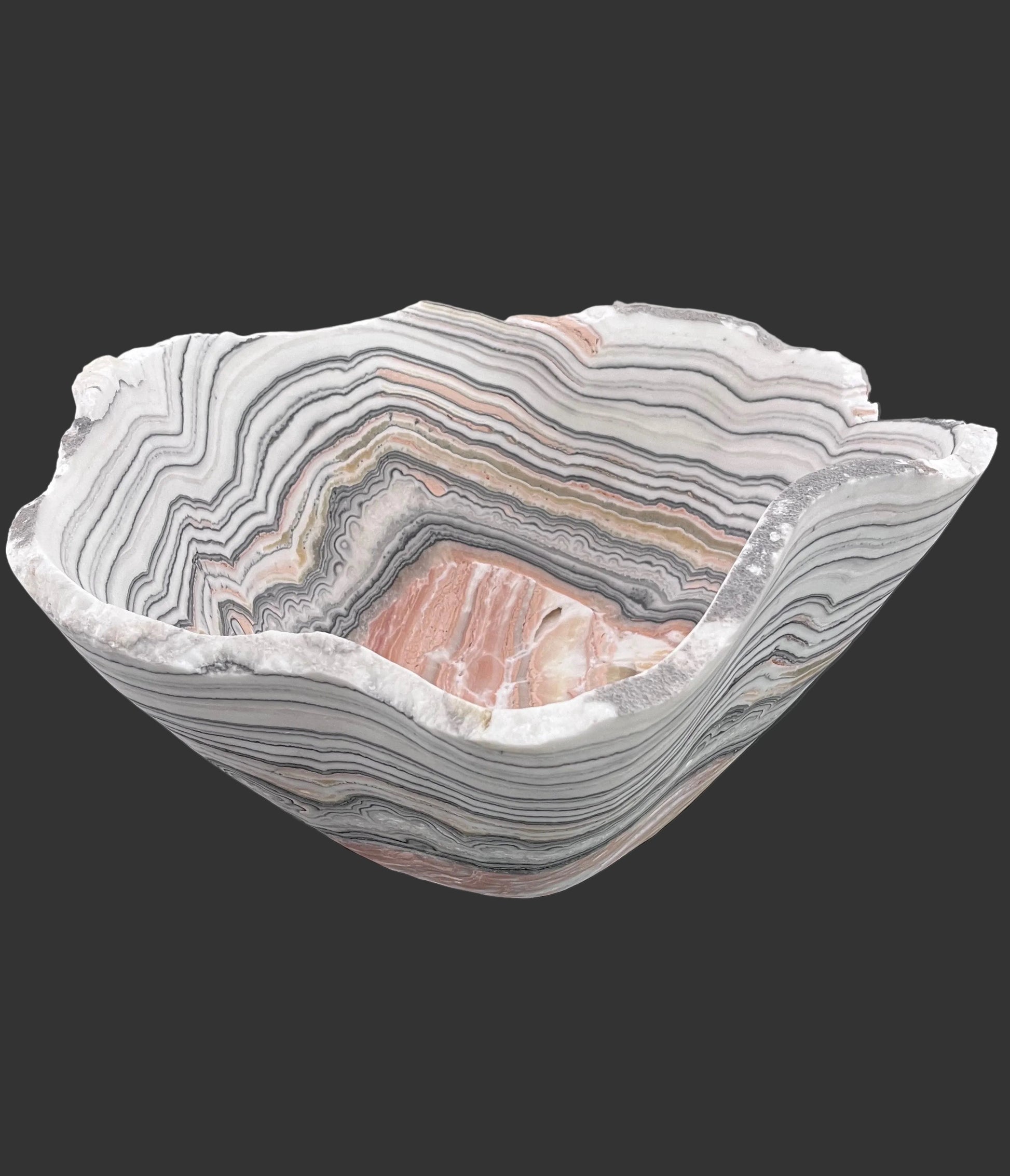 Decorative bowl with zebra calcite pattern on a black surface