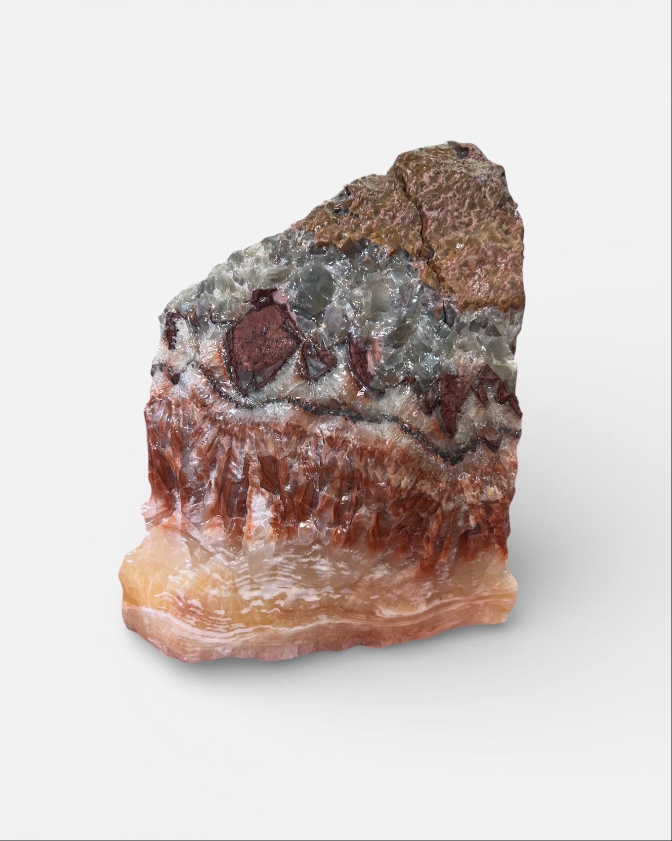 Raw tri-color banded calcite with amber, blush, and gray crystal layers in natural unpolished form