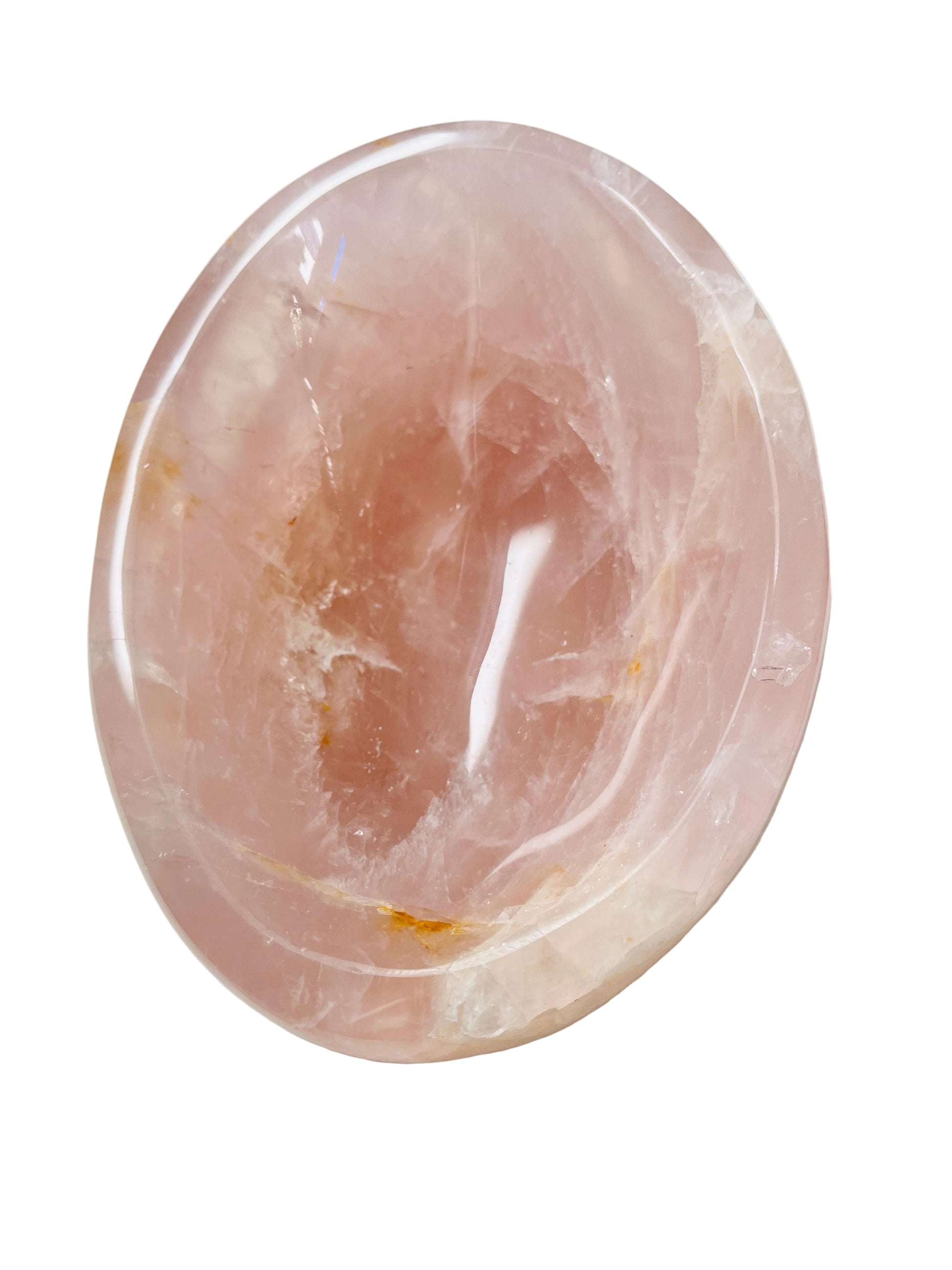 Polished pink quartz bowl on a white surface