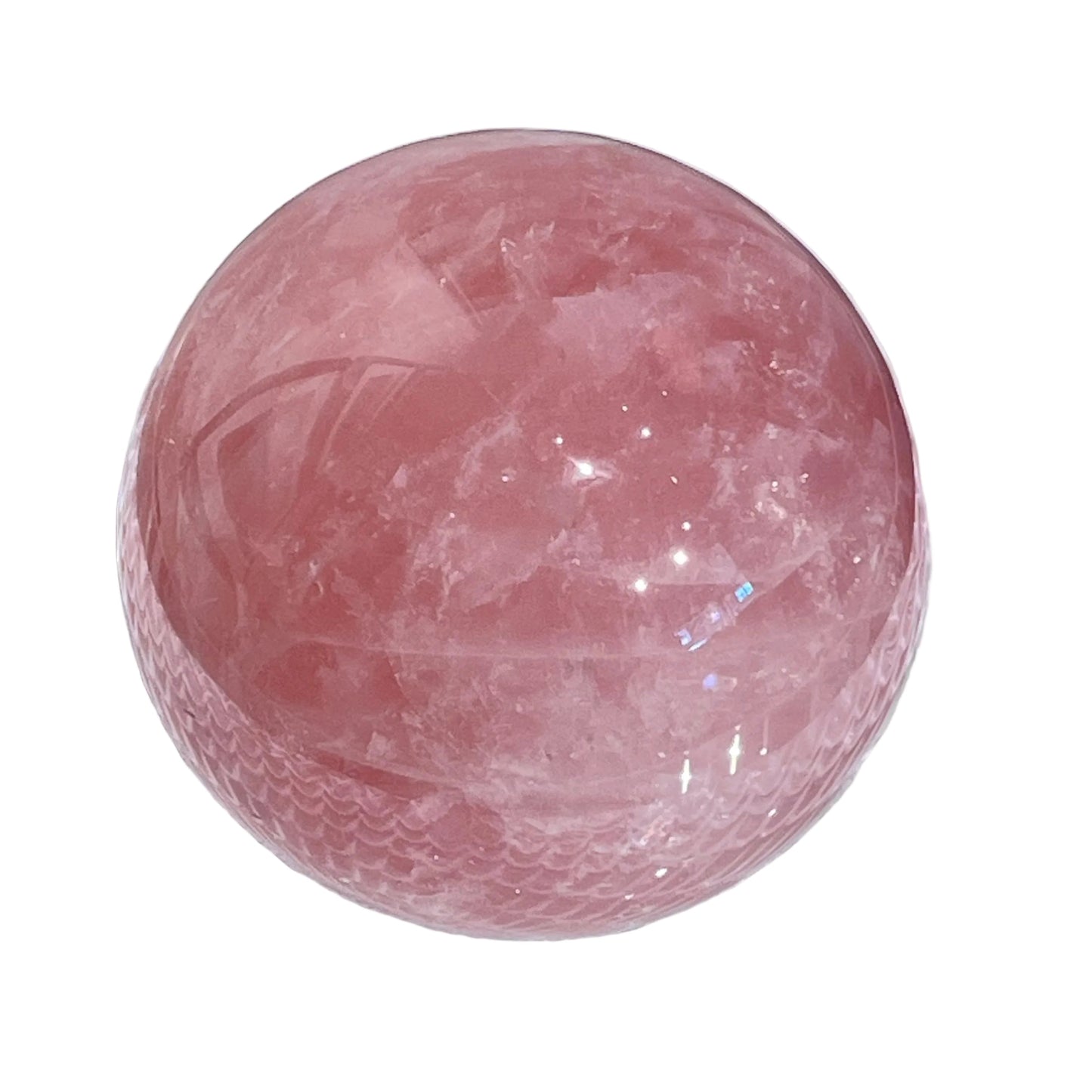 Pink crystal sphere on a textured white surface with a gray background
